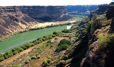 [The river disappears around a bend in the distance. The sky is so bright the river looks green in this area.]